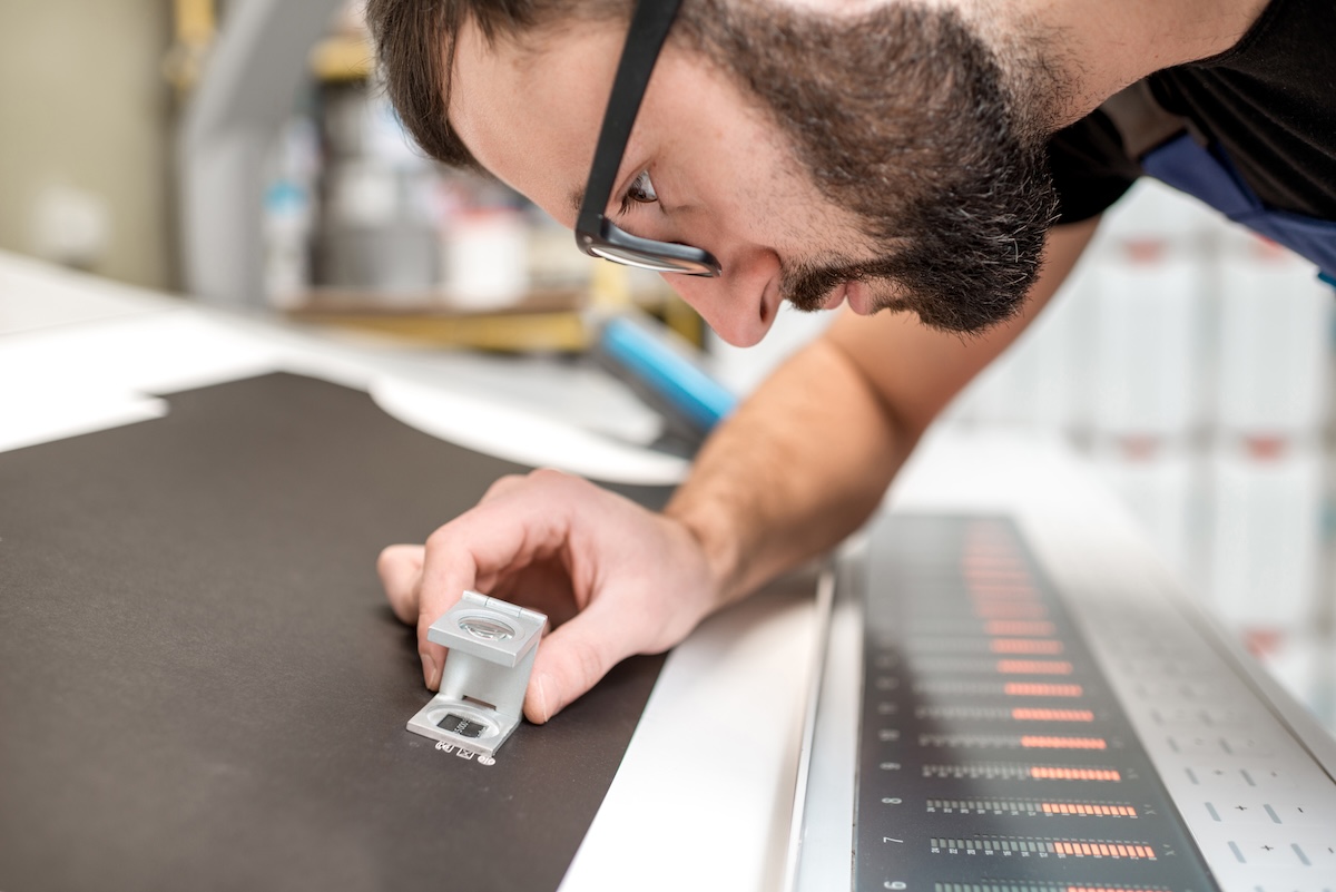Checking the quality of the printing with magnifying glass
